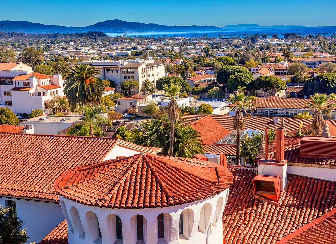 About Our Agency - View of Red Tile Buildings on the Courthouse in Santa Barbara California with Other Commercial and Residential Buildings in the Distance on a Sunny Day