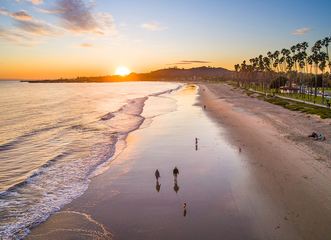 Contact - Aerial View of People Walking on the Beach in Santa Barbara California at Sunset